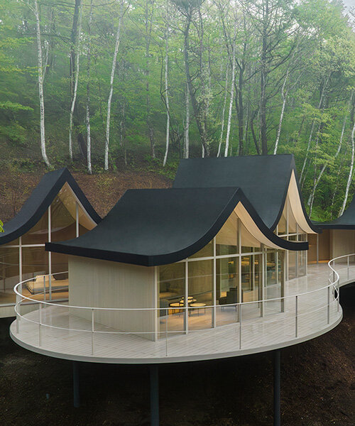 nendo weaves six cottages together with 'hand-holding' roofs in japanese forest house